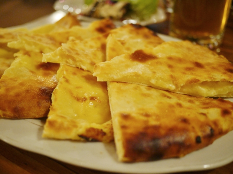 This is Ossetian khachapuri, which looks a lot like Imeretian but has an additional filling of potato.  Tasty.